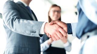 Business people shaking hands, finishing up a meeting