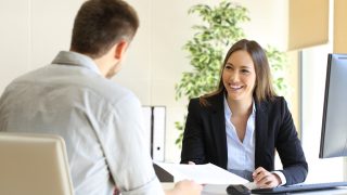 Guy Giving A Curriculum Vitae To His Interviewer