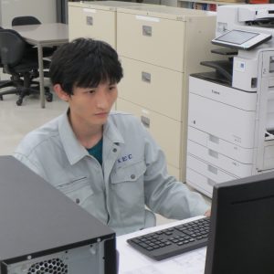 パソコンに向かって作業するクエンさん